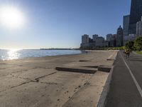 some people are jogging on the beach in chicago during the sun is rising over water