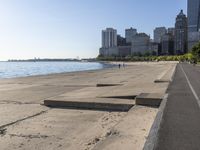 some people are jogging on the beach in chicago during the sun is rising over water