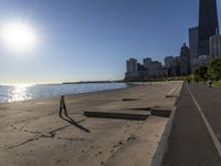 some people are jogging on the beach in chicago during the sun is rising over water