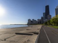 some people are jogging on the beach in chicago during the sun is rising over water