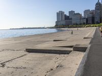 some people are jogging on the beach in chicago during the sun is rising over water