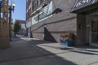 there is a building and a sign that reads los on it's side next to some blue planters