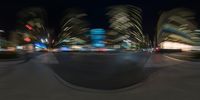 a blurry photo shows cars at a busy intersection during night time a high - rise building is in the background