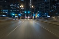 the blurry image shows an empty street with lots of light and traffic going down it