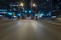 the blurry image shows an empty street with lots of light and traffic going down it