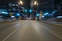 the blurry image shows an empty street with lots of light and traffic going down it