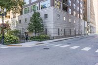 a two story building is on a side walk in the middle of an intersection with a bike lane