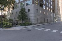 a two story building is on a side walk in the middle of an intersection with a bike lane