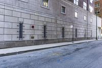 there is a stop sign in the street outside of a building, next to a street