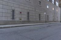 there is a stop sign in the street outside of a building, next to a street