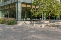 the child is playing on the skateboard in the plaza in front of the building