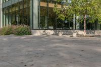 the child is playing on the skateboard in the plaza in front of the building