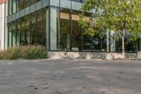 the child is playing on the skateboard in the plaza in front of the building