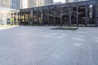 a small child is running in front of the glass buildings on the street as he rides a skateboard