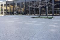 a small child is running in front of the glass buildings on the street as he rides a skateboard