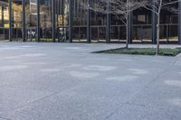 a small child is running in front of the glass buildings on the street as he rides a skateboard