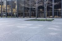 a small child is running in front of the glass buildings on the street as he rides a skateboard