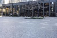 a small child is running in front of the glass buildings on the street as he rides a skateboard