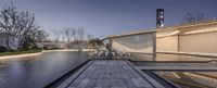 the view from the water feature and the glass ceiling to the left shows the building as it sits alone in the middle of a pool