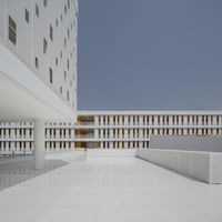 this courtyard is filled with lots of white brick building floors and walls that are lined in strips