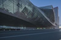 the modern buildings are surrounded by glassy and shiny windows and street lights for pedestrians