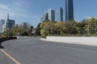 a white car is driving down a city street in front of tall buildings and buildings