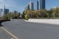 a white car is driving down a city street in front of tall buildings and buildings