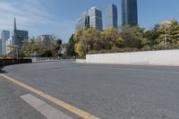 a white car is driving down a city street in front of tall buildings and buildings