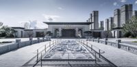 a long courtyard of an old chinese style building with ornamental designs and a fountain with a clear sky behind it