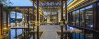 modern chinese lobby and entrance at night by the lake with its lighted water feature and trees surrounding