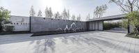 a concrete wall with bicycle artwork at a park area in chinas zhejiang county, where public transportation is an option