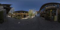 360 - image photograph of an entrance to an outdoor restaurant in china with the sun streaming through