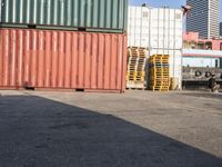 a cat sitting in a room next to some shipping containers and buildings on the street