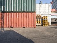 a cat sitting in a room next to some shipping containers and buildings on the street