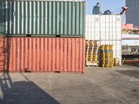 a cat sitting in a room next to some shipping containers and buildings on the street