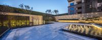 the water features of the long water feature in a backyard setting, including fountains and lighting