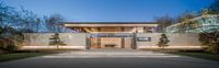 a house designed by japanese architecture firm is seen in this image from a distance on the sidewalk