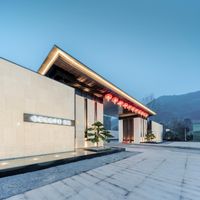 a very clean, light stone building that's lit up for the camera with the words gourmet