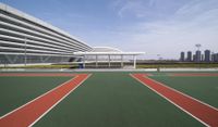 the tennis courts have been placed under a building that has a futuristic design in front of it