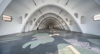 a huge white building with an animal pattern on the floor and light on top of it