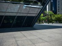 a city plaza with a bus and a man walking toward it near many skyscrapers