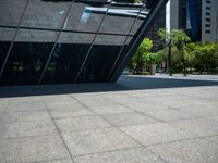 a city plaza with a bus and a man walking toward it near many skyscrapers