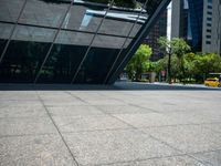 a city plaza with a bus and a man walking toward it near many skyscrapers