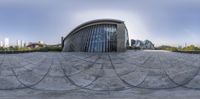 a fisheye lens picture of a building with many circular curves that mean to the city on the outside