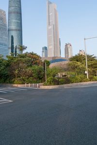 a view from the back of a car's corner on a street with tall buildings