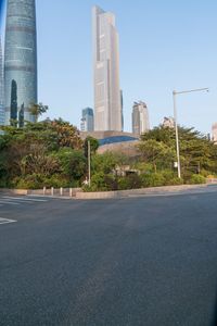 a view from the back of a car's corner on a street with tall buildings