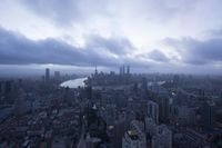 a boat is traveling through a large river next to the city of shanghai, china