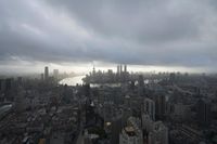 a boat is traveling through a large river next to the city of shanghai, china