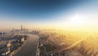 an aerial photo looking down onto the city skyline during sunset near the water's edge