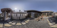 360 - camera photo of people sitting outside of cabins at the beach in california city